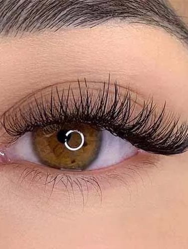 a woman's with hybrid eyelash extensions eyeliners and lasheshadow on her eyeliners