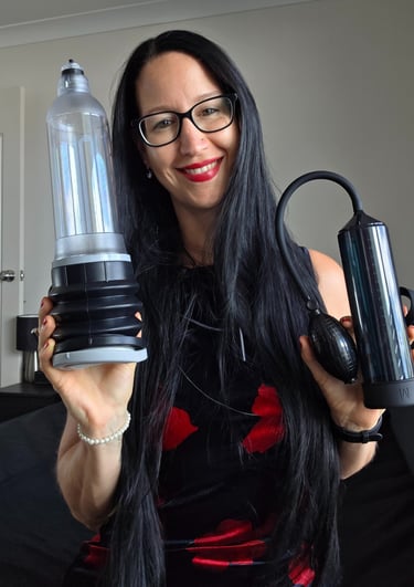 Pleasurelit Patricia holding two different penis pumps for tips