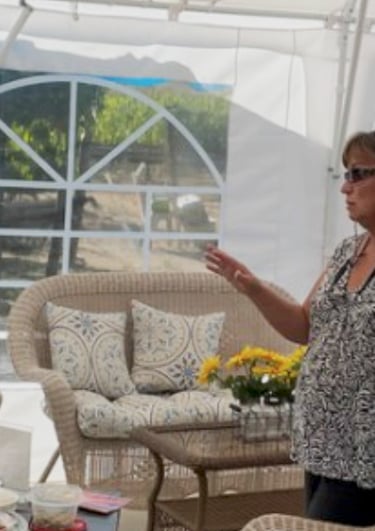 Ginny chatting with wine members in the tent