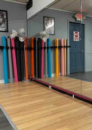 a mirror reflecting a mirror in a room with a row of seamless backdrops