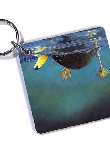 a keychain with a picture of a duck swimming in the ocean