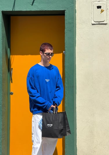 a man in a blue sweatshirt and white pants. un hombre con una sudadera azul y pantalones blancos