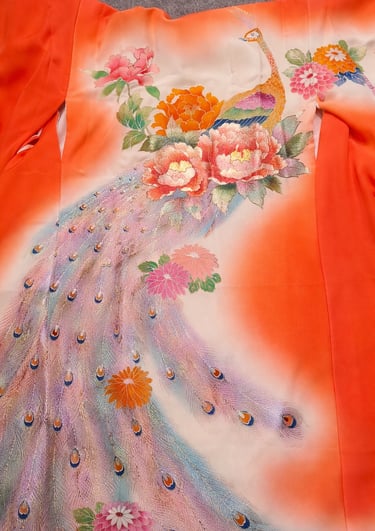 Vintage Japanese orange silk kimono featuring an embroidered peacock with floral peony motifs.