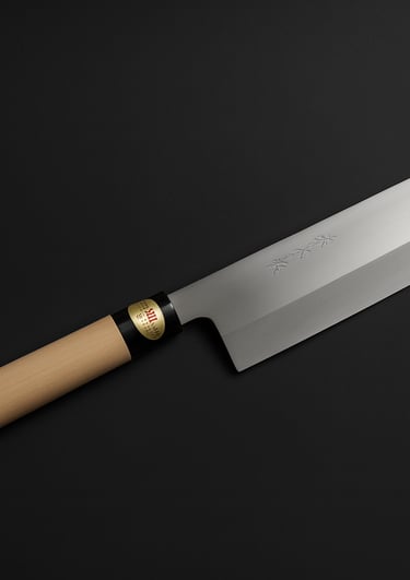 Professional Japanese Nakiri vegetable knife with a carbon steel blade and wooden handle on a black background.