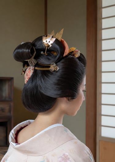 Traditional Japanese geisha hairstyle with ornate gold kanzashi hair pins and silk kimono.
