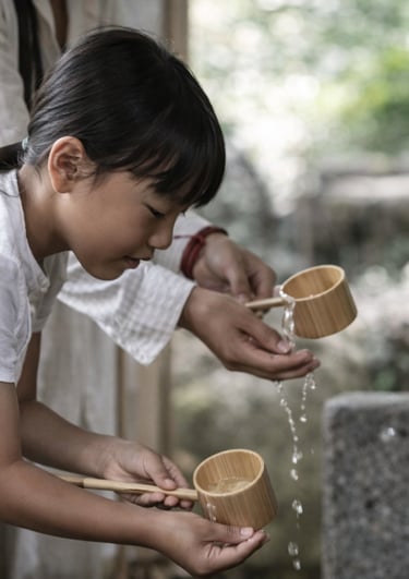 Young Japanese girl performing a water purification ritual with bamboo ladles at a Shinto shrine.