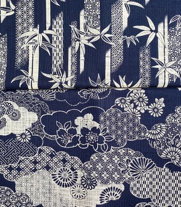Japanese indigo blue fabric with traditional white bamboo leaves and floral cherry blossom patterns.