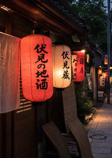 Traditional red and white Japanese paper lanterns hanging outside a restaurant on a Kyoto street at night.