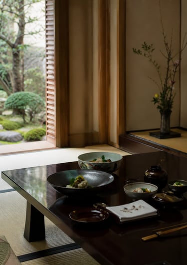 Traditional Japanese kaiseki meal served on a low dark wood table in a room overlooking a Zen garden.