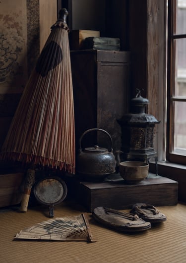 Vintage Japanese interior with a wagasa paper umbrella, tetsubin kettle, and traditional Geta sandals on tatami matting.