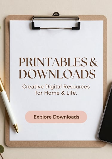 Clipboard with printable and digital resources text, gold pen, smartphone, and eucalyptus stems on a desk.