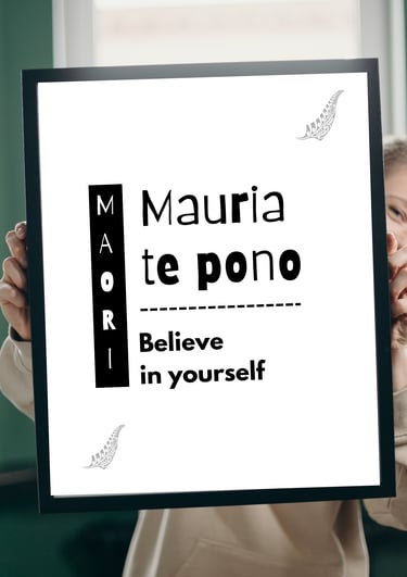 Minimalist Maori proverb wall art poster held by a woman, featuring cultural quote typography design
