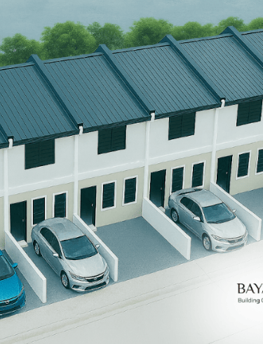 Aerial view of Bayanihan Town modern white row houses with cars parked in private driveways.