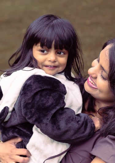a woman in a panda bear suit is holding a stuffed animal
