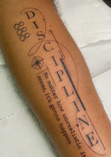 a tattoo on a man's leg with a tattoo of a guitar