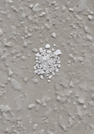 Close-up of granular ice melt crystals scattered on a snowy surface.