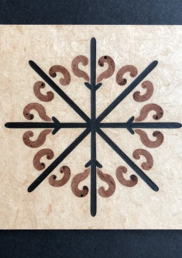 A person holding a paper plate with a circular design on it