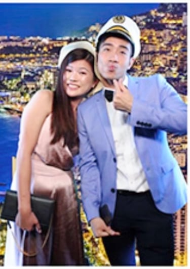 Couple posing with a Green Screen taken at a celebration Mirror Photo Booth.
