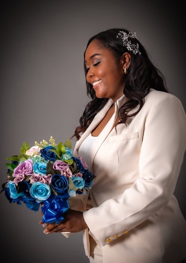 a woman in a white suit and a bouquet of flowers