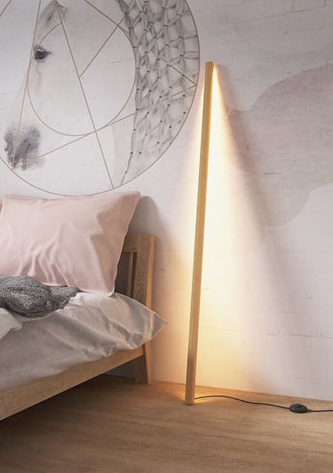 a bed with a lamp and a lamp on the side of the bed