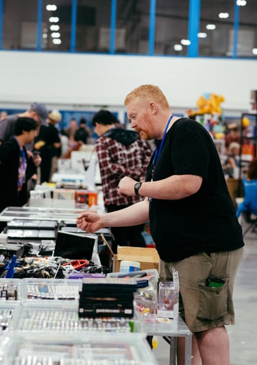A collector looks through the video games for sale at a vendor booth