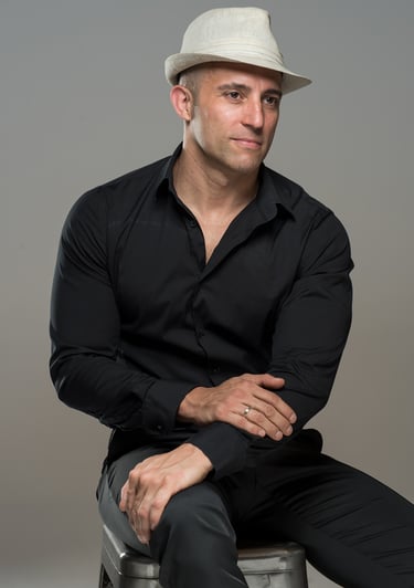 a man in a hat and a hat on a chair