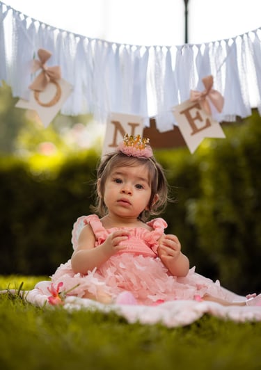 little girl posing in front of the camera to get her picture taken by a photographer in visalia