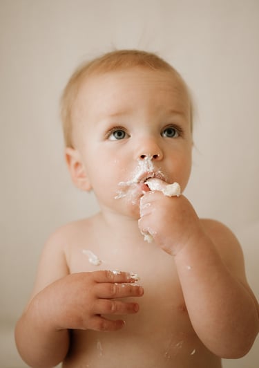 toddler eating cake as part of cake smash photography session in Adelaide