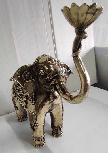 "Tribal-style brass elephant holding lotus flower, raised trunk posture, right side-Export-ready"