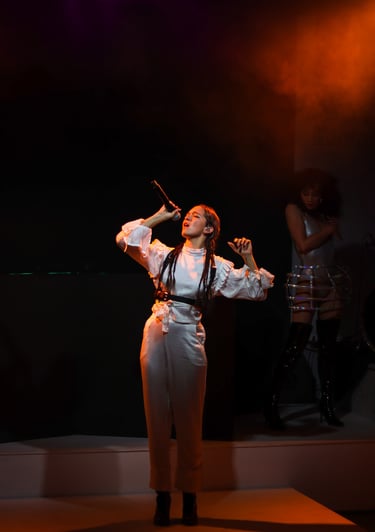 a woman in a white dress and a microphone