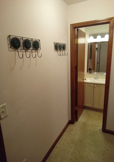 hallway leading to 1/2 bath