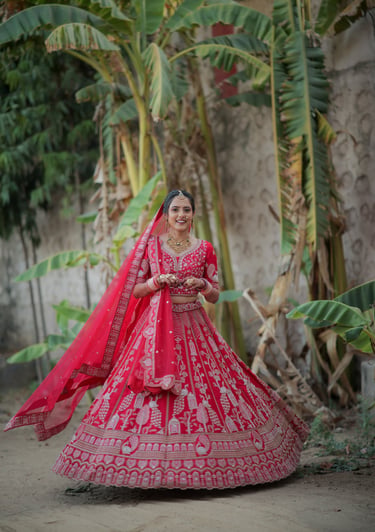 “Bride twirling in red bridal lehenga and choli during wedding photoshoot in Gotri, Vadodara – brida