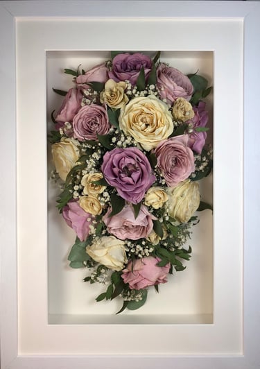a trailing view Style bouquet of flowers in a thick white frame