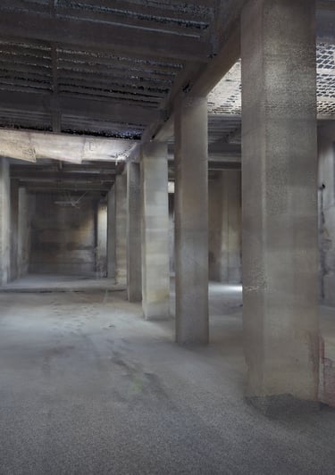 A detailed 3D point cloud scan of an empty industrial warehouse interior with concrete pillars.