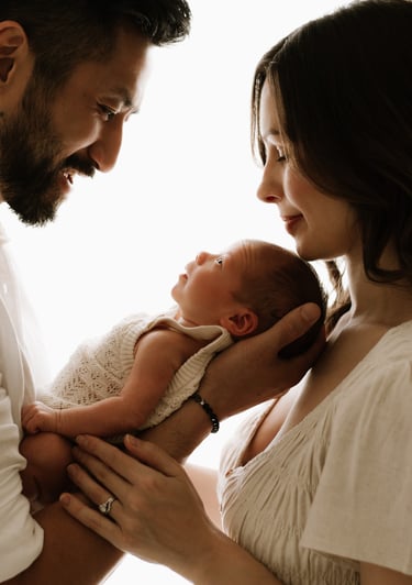 newborn looking up at parents in a newborn studio photo session, Adelaide Hills 