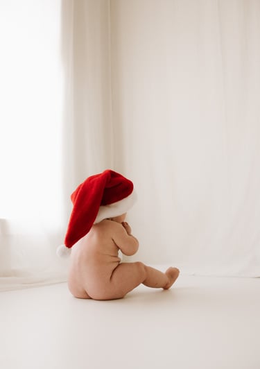 baby with a christmas hat on taken as a milestone session in studio, Adelaide Hills