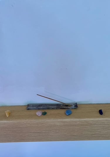 image shows 7 gemstones representing the 7 chakra colours, along with some incense