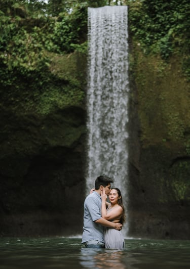 Intimate couple under waterfall at Tibumana Waterfall Bangli Bali