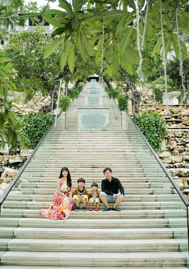 Family photography session on the Grand Staircase at The Apurva Kempinski Bali overlooking the Indian Ocean