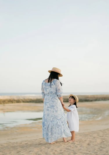 Family portrait overlooking the shoreline at The Apurva Kempinski Bali.