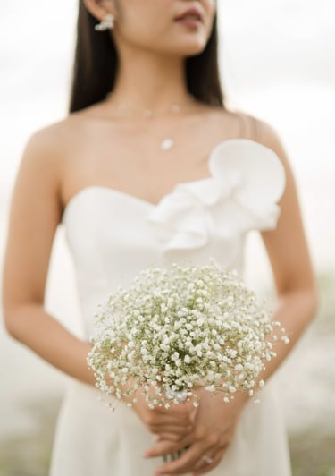 Bride portrait holding bouquet during sunset bridal session at Melasti Beach Bali