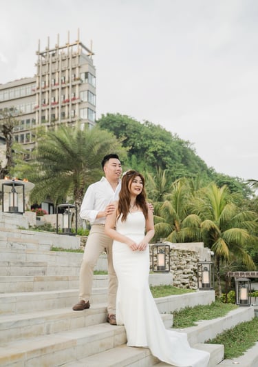 Couple portrait on the grand staircase of Apurva Kempinski Bali during a romantic prewedding photoshoot