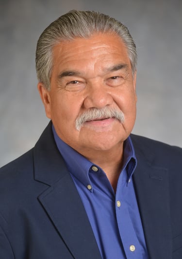 Daniel Solózano with a mustache smiling toward the camera