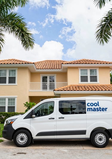 A skilled HVAC technician carefully installing a sleek air conditioning unit in a modern South Florida home.