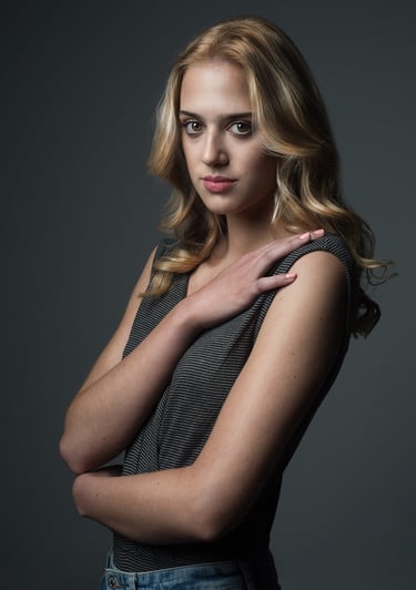 a woman with blonde hair and a gray top