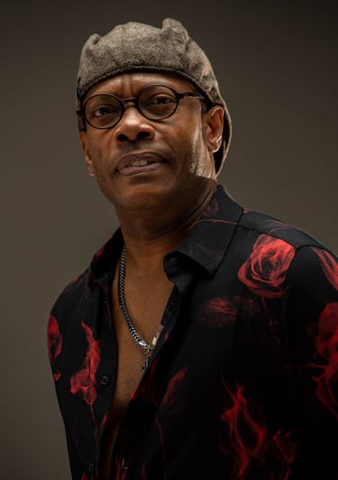 a man in a hat and glasses is smiling