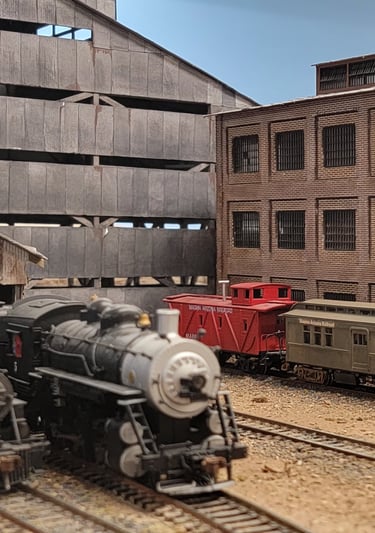 Steam train, Caboose with surronding buildings.