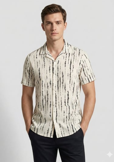 a man in a shirt and pants standing in front of a white wall