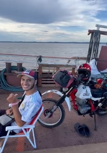 a man sitting in a chair with a helmet on
