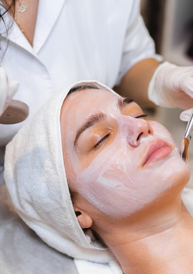 a woman getting a facial mask with a facial mask